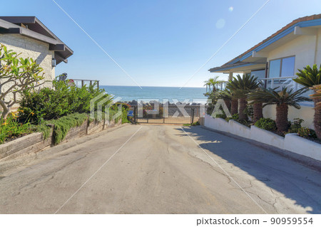 Concrete pathway heading to the gate exit with garden beds on the side in San Clemente, California 90959554