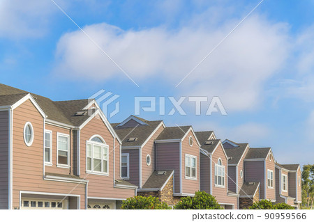 Row of townhouses with pink wood vinyl sidings at Carlsbad, San Diego, California 90959566
