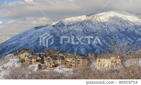 Pano Large houses on top of a snowy hill with Mount Timpanogos view at Draper, Utah 90959754