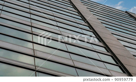 Panorama White puffy clouds Low angle view of a rise building facade with reflective glass w Panorama White puffy clouds Low angle view of a rise building facade with reflective glass w 90959779