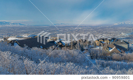 Panorama Whispy white clouds High angle view of Draper residential area in Utah 90959801