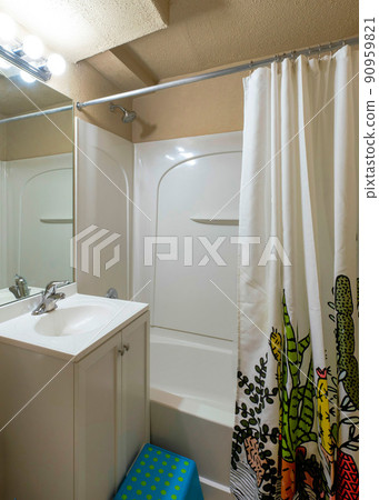 Vertical Interior of a bathroom with white shower curtain with printed cactus design Vertical Interior of a bathroom with white shower curtain with printed cactus design 90959821