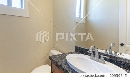 Pano Interior of a cream colored bathroom with windows and sink 90959845