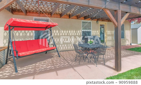 Panorama Outdoor patio of a house with loung seats and covered barbecue griller Panorama Outdoor patio of a house with loung seats and covered barbecue griller 90959888