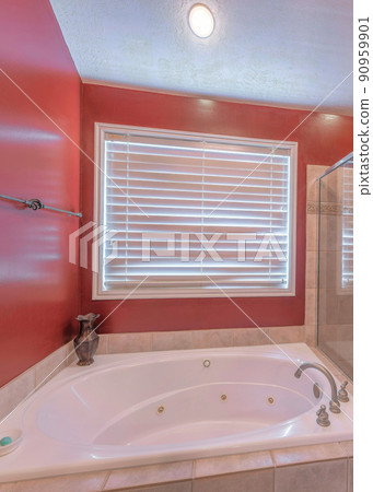Vertical Red bathroom interior with shower stall and drop in bathtub with ceramic tiles surround Vertical Red bathroom interior with shower stall and drop in bathtub with ceramic tiles surround 90959901