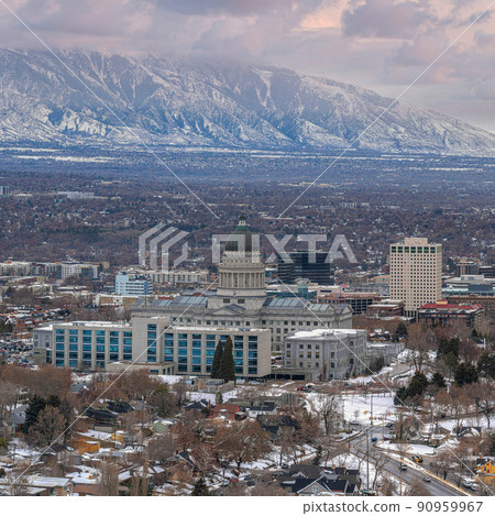 Square Puffy clouds at sunset Downtown Salt Lake City aerial view against the snowy mountain r 90959967