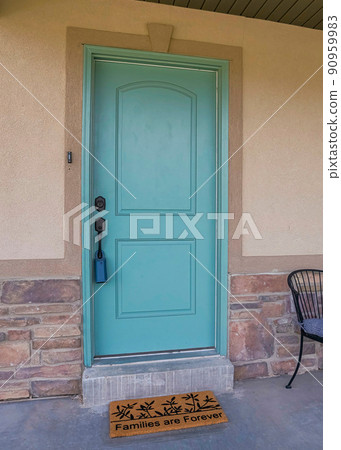 Vertical Front porch exterior with mint green door and decorative doormat 90959983
