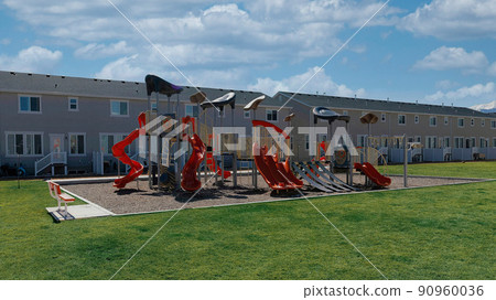 Panorama White puffy clouds Playground on a field outside the complex buildings of townhouse 90960036