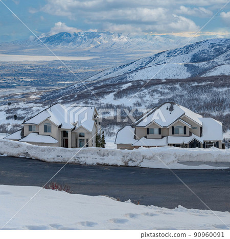 Square White puffy clouds Uphill snowy residential area at Draper in Utah with a view of W 90960091