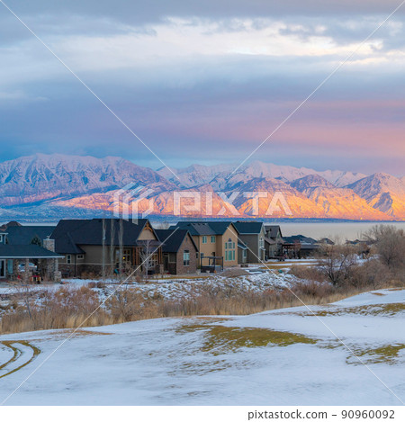 Square Whispy white clouds Snow covered field outside the residential area at Saratoga Springs in Utah 90960092