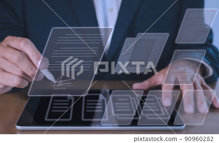 businessman use electronic pen sign signature on electronic  E-signing, data sheet document management, paperless office concept. Businessman using stylus pen signing e document on digital tablet. 90960282