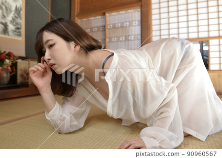 A young woman wearing a shirt in lingerie posing in a Japanese-style room in an old folk house A young woman wearing a shirt in lingerie posing in a Japanese-style room in an old folk house 90960567