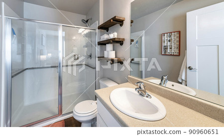 Pano Interior of a full bathroom with shelves and cabinet 90960651