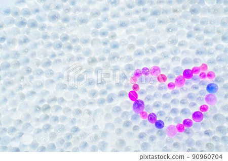 A lovely red and purple heart symbol made of silica gel, a round granular dehydrating agent. 90960704