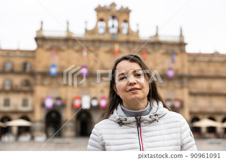 Smiling female tourist enjoying walking in Plaza Mayor in Salamanca Smiling female tourist enjoying walking in Plaza Mayor in Salamanca 90961091