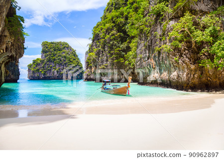 Thai traditional wooden longtail boat and beautiful beach in Phuket province, Thailand. Thai traditional wooden longtail boat and beautiful beach in Phuket province, Thailand. 90962897