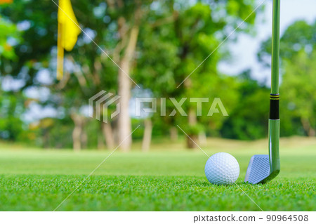 Golf ball on green grass ready to be struck on golf course 90964508
