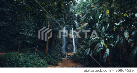 Waterfall in the tropical forest in the rainy season 90964529