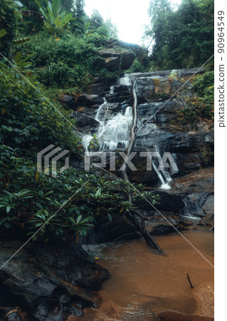 Waterfall in the tropical forest in the rainy season 90964549
