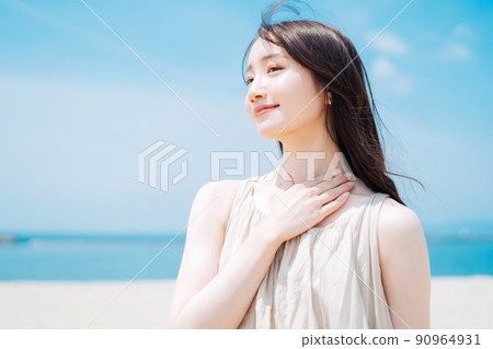 Woman applying sunscreen at sea Woman applying sunscreen at sea 90964931