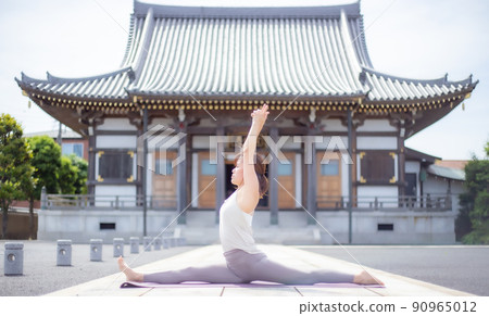 A woman doing yoga at a temple A woman doing yoga at a temple 90965012