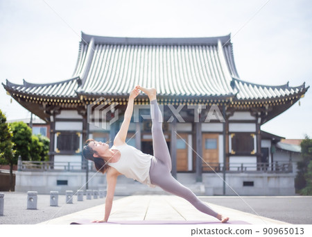 A woman doing yoga at a temple A woman doing yoga at a temple 90965013