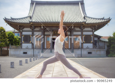 A woman doing yoga at a temple A woman doing yoga at a temple 90965249