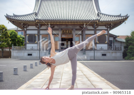 A woman doing yoga at a temple 90965318