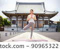 A woman doing yoga at a temple 90965322