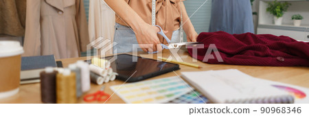 Fashion design concept, Asian female fashion designer is tailoring clothes for the new collection Fashion design concept, Asian female fashion designer is tailoring clothes for the new collection 90968346