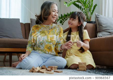 Asian portrait, grandma and granddaughter doing leisure activities and hugging to show their love and care for each other. Asian portrait, grandma and granddaughter doing leisure activities and hugging to show their love and care for each other. 90968567