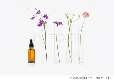Natural medicine or aroma essential oil concept vials with dropper and flowers 90969512