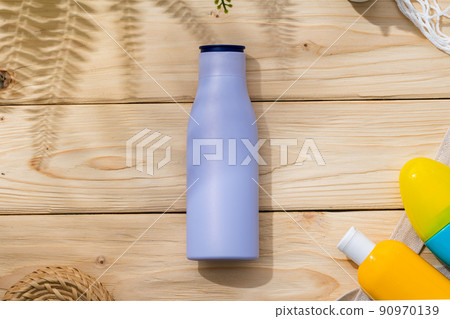 Sunscreen cream bottles in beach bag on wooden background 90970139