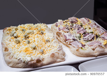 two raw Roman Pizza al taglio with egg and cheese and ham 90970557
