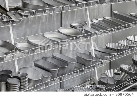 empty metal molds, trays and racks for baking bread and bakery products in a bakery 90970564