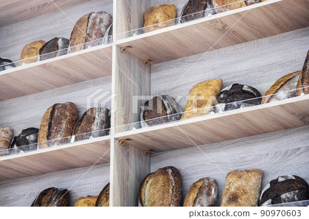 many different types of bread. Wholegrain, round, rolls and loaves 90970603