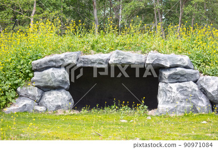 Man made cave, overgrown with grass Man made cave, overgrown with grass 90971084