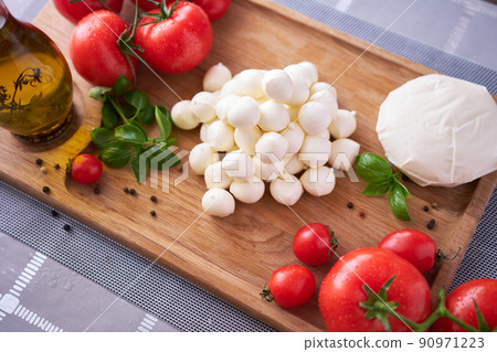 Ingredients for Caprese salad - Mini mozzarella cheese in glass bowl, tomato and basil 90971223