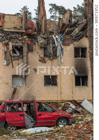Shot cars. On the streets of Irpin. Cities of Ukraine after the Russian occupation. Irpin, Bucha, Hostomel. Destroyed and burnt houses in the background. Shot cars. On the streets of Irpin. Cities of Ukraine after the Russian occupation. Irpin, Bucha, Hostomel. Destroyed and burnt houses in the background. 90971952