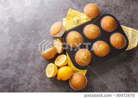 Delicious healthy muffins with poppy seeds and lemon zest close-up in a metal muffin pan. horizontal top view 90972670