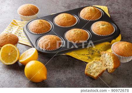 Delicious healthy muffins with poppy seeds and lemon zest close-up in a metal muffin pan. horizontal Delicious healthy muffins with poppy seeds and lemon zest close-up in a metal muffin pan. horizontal 90972678