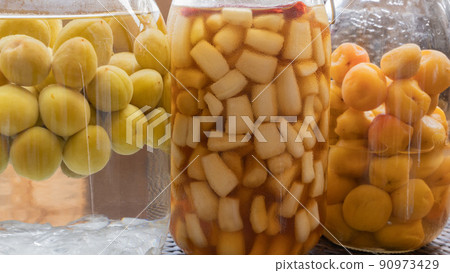 Umeboshi pickled in a fruit liquor bottle, plum wine, pickled in sweet and sour sauce (up focus on scallions) Umeboshi pickled in a fruit liquor bottle, plum wine, pickled in sweet and sour sauce (up focus on scallions) 90973429
