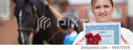 Woman doctor shows horse veterinary certificate Woman doctor shows horse veterinary certificate 90975939