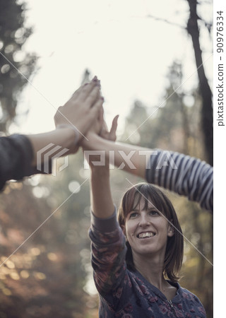Group of people giving a high fives gesture Group of people giving a high fives gesture 90976334