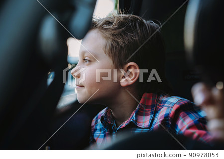 Handsome caucasian boy travelling by car sitting in child seatRecreation concept 90978053