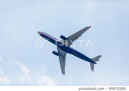 Passenger plane flies in the blue sky with clouds. Aviation industry 90978260