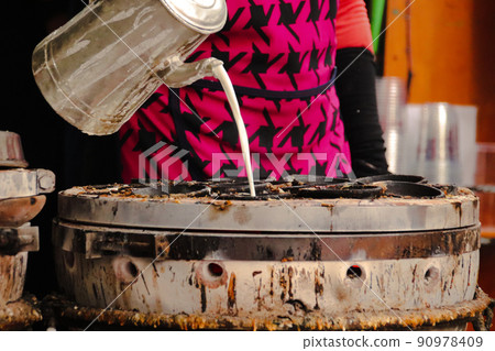 Streetfood vendor pouring batter to make Banh Khot or Vietnamese Rice Pancakes Streetfood vendor pouring batter to make Banh Khot or Vietnamese Rice Pancakes 90978409