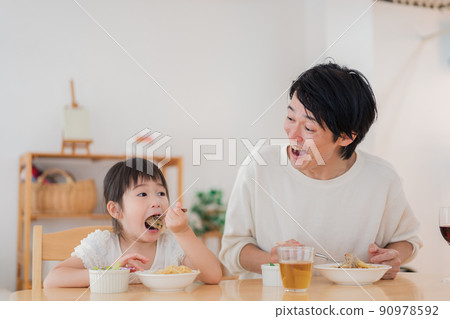Daddy eating rice with his daughter 90978592