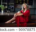 Beautiful adult woman sitting in the kitchen 90978875