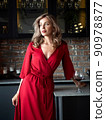 Beautiful adult woman standing in the kitchen 90978877
